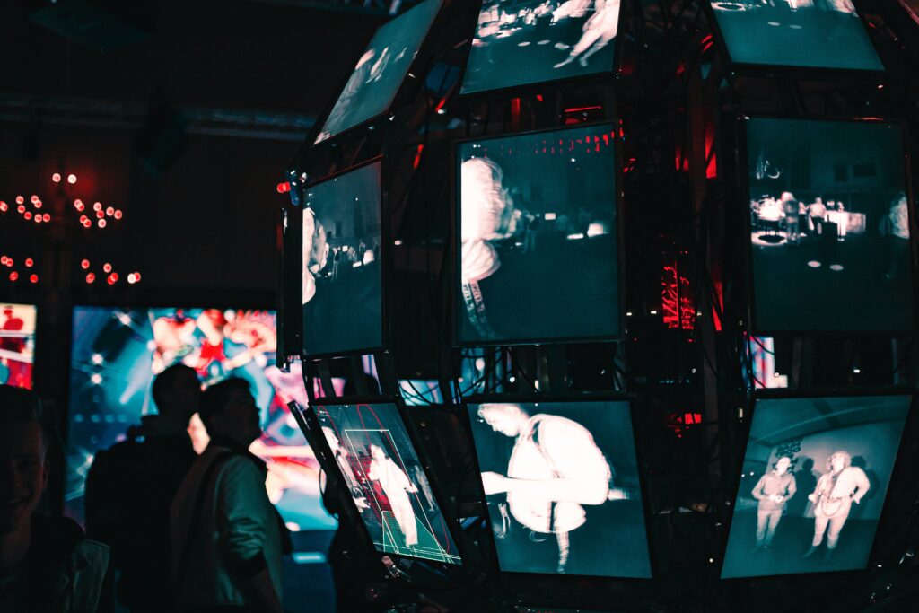 shadows of two persons staring at hug computer screens